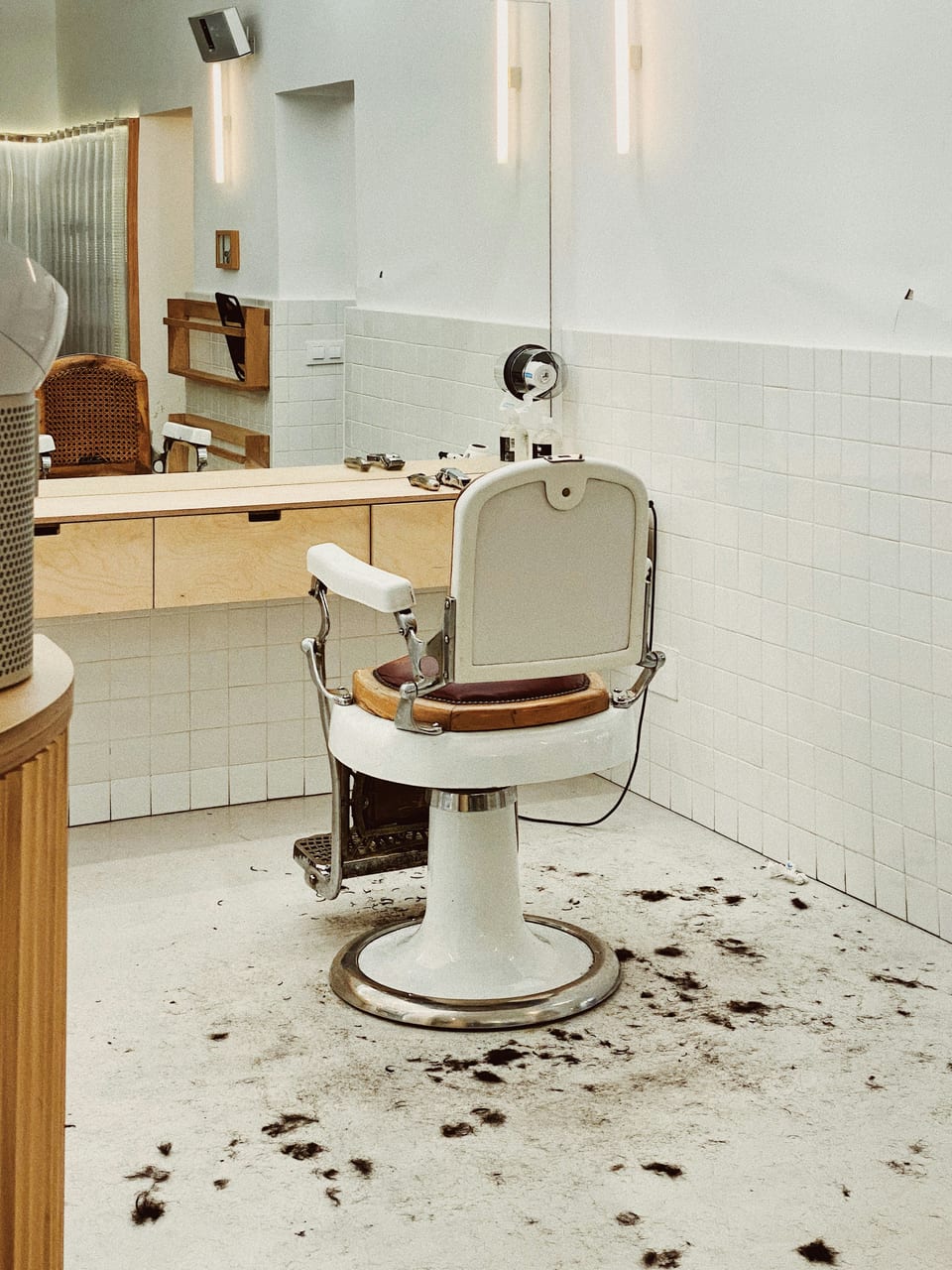 Cream and brown salon chair beside a mirror